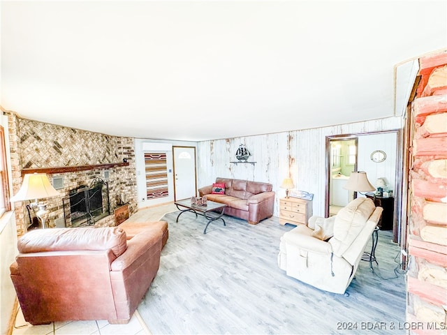 living area with light wood-type flooring and a large fireplace