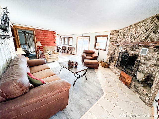 living area with a fireplace and light tile patterned floors