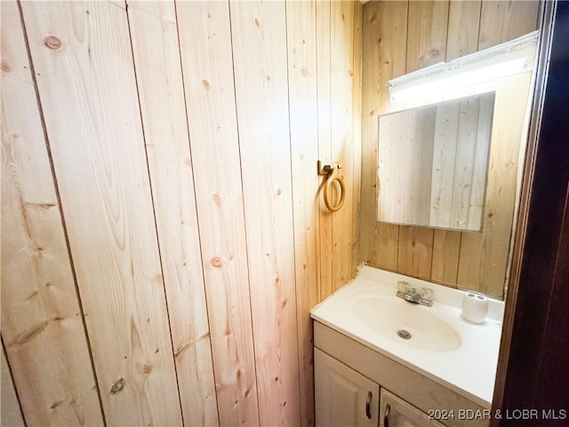 bathroom with wooden walls and vanity