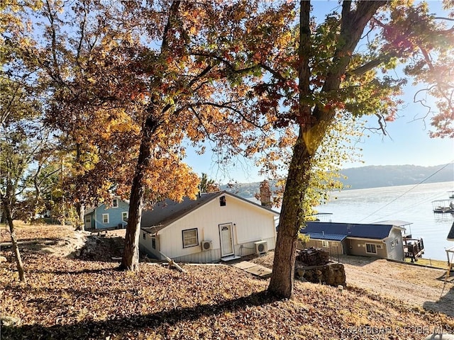 exterior space with a water and mountain view