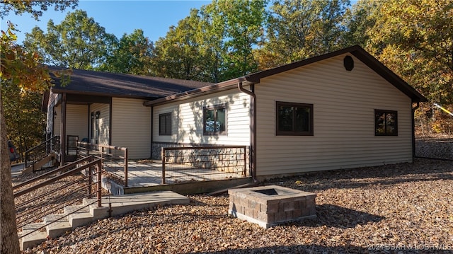 view of side of home featuring an outdoor fire pit