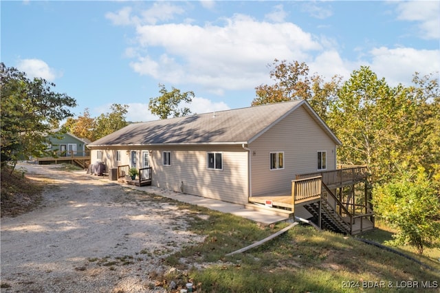 view of side of home with a deck