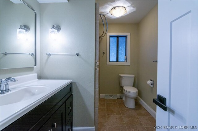 641 Porter Mill Springs Rd, Sunrise Beach, MO 65079 - bathroom with vanity, toilet, baseboards, tile patterned flooring, and a shower