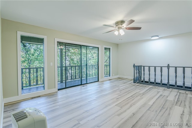 spare room featuring light hardwood / wood-style floors and ceiling fan