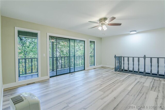 641 Porter Mill Springs Rd, Sunrise Beach, MO 65079 - unfurnished room with a ceiling fan, wood finished floors, and baseboards