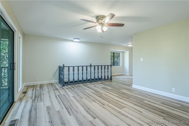 spare room with light wood-type flooring and ceiling fan