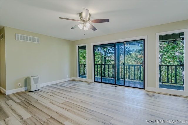 unfurnished room with light hardwood / wood-style floors and ceiling fan