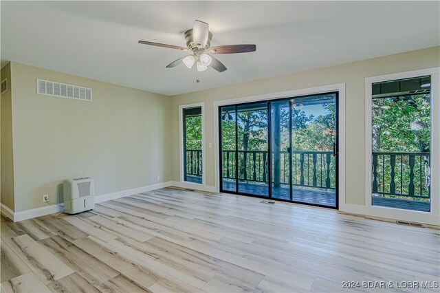 641 Porter Mill Springs Rd, Sunrise Beach, MO 65079 - empty room with a ceiling fan, wood finished floors, and baseboards