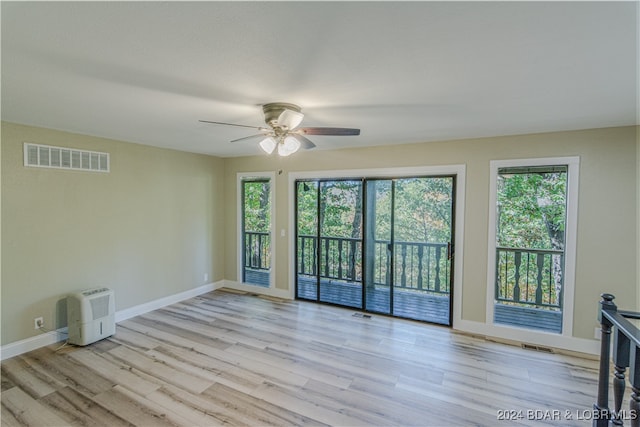 spare room with ceiling fan and light hardwood / wood-style flooring