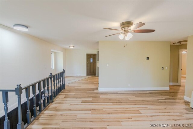641 Porter Mill Springs Rd, Sunrise Beach, MO 65079 - hall with light wood finished floors, baseboards, and an upstairs landing