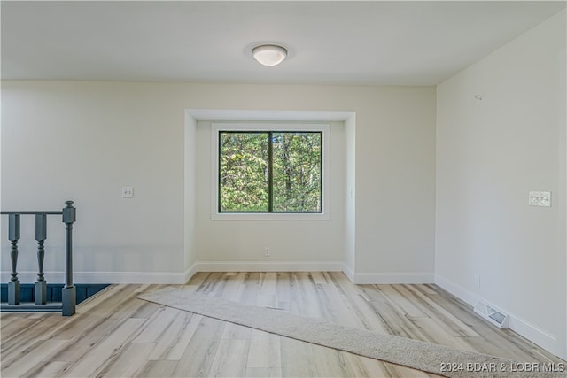 spare room with light hardwood / wood-style flooring