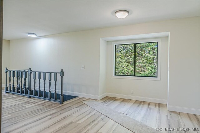 641 Porter Mill Springs Rd, Sunrise Beach, MO 65079 - unfurnished room with wood finished floors and baseboards