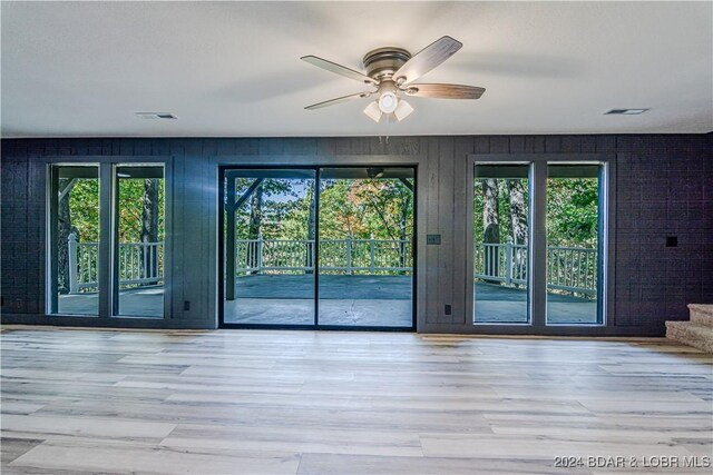 641 Porter Mill Springs Rd, Sunrise Beach, MO 65079 - doorway to outside with a ceiling fan and wood finished floors