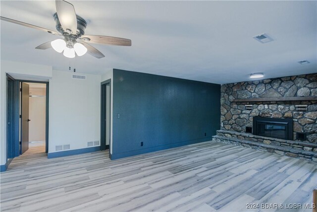 641 Porter Mill Springs Rd, Sunrise Beach, MO 65079 - unfurnished living room with light wood-style flooring, ceiling fan, baseboards, and a fireplace