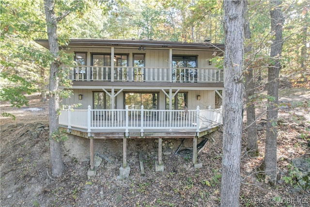 back of property with a balcony