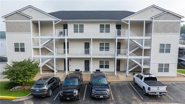 4935 Robins Cir Unit 111, Osage Beach, MO 65065 - view of building exterior featuring uncovered parking and stairs