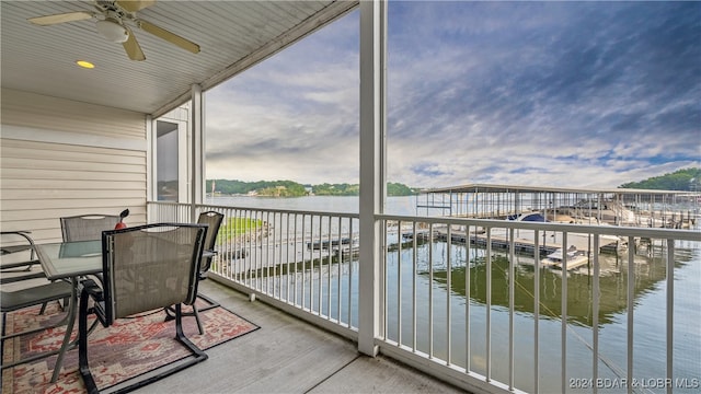 balcony with a water view and ceiling fan