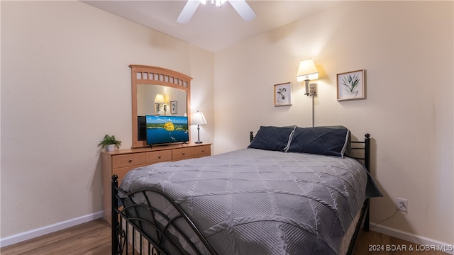 bedroom with lofted ceiling, wood-type flooring, and ceiling fan