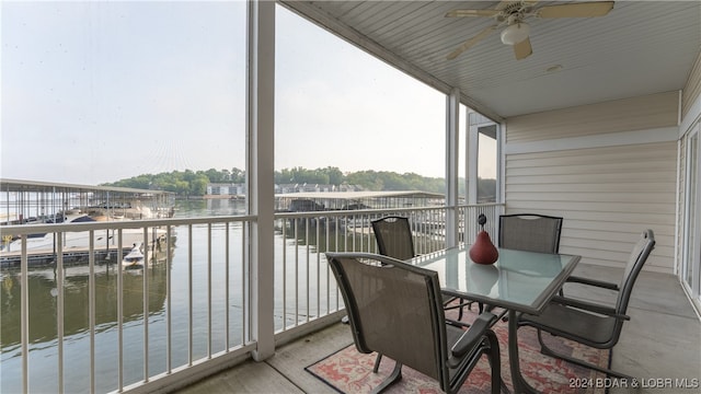 balcony with a water view and ceiling fan