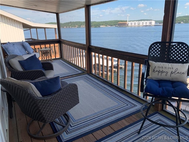 wooden terrace featuring a water view