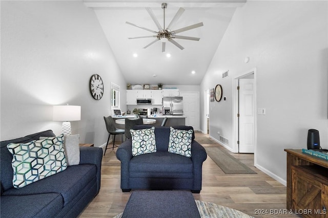 living room featuring visible vents, light wood finished floors, baseboards, high vaulted ceiling, and a ceiling fan