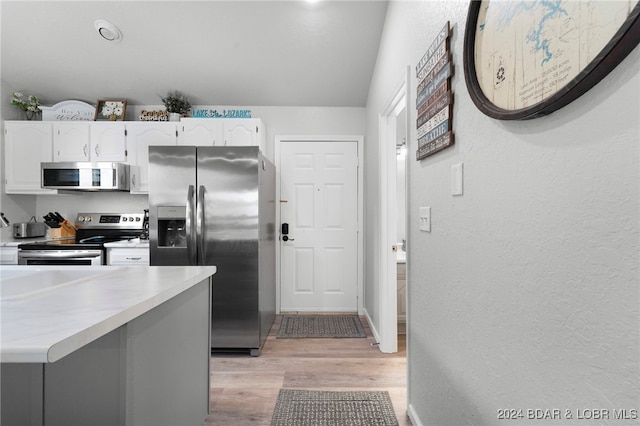 kitchen featuring white cabinetry, light hardwood / wood-style flooring, and appliances with stainless steel finishes