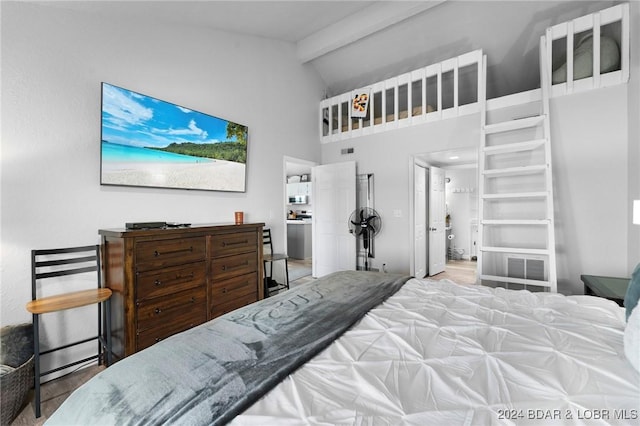 bedroom with high vaulted ceiling, wood finished floors, and visible vents