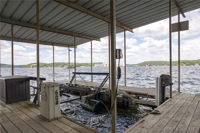 dock area with a water view and boat lift