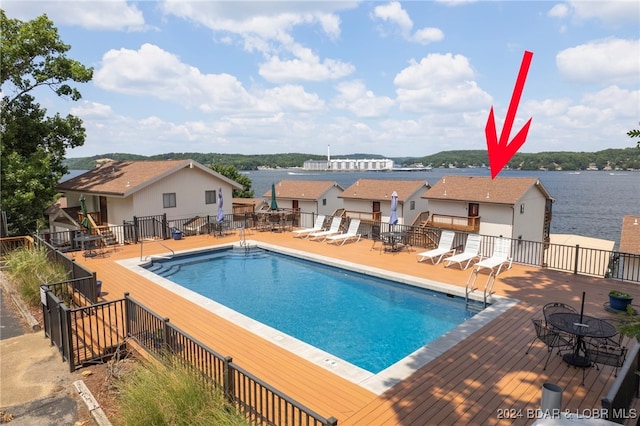 view of pool featuring a deck with water view