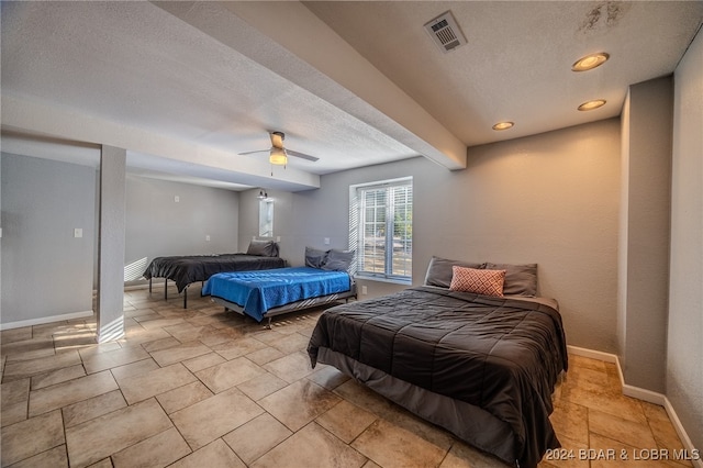 bedroom featuring ceiling fan and a textured ceiling