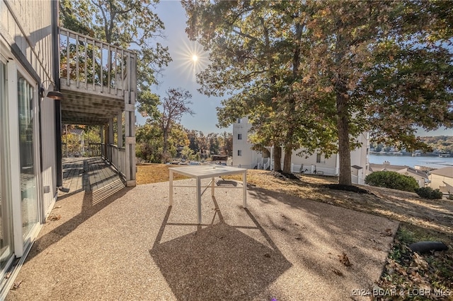 view of patio / terrace with a water view and a balcony