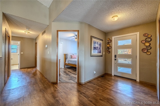 entryway with ceiling fan, hardwood / wood-style flooring, and a textured ceiling