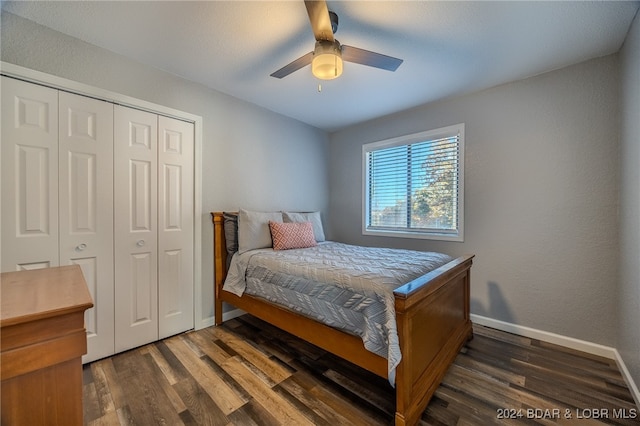 bedroom with a closet, dark wood-type flooring, and ceiling fan