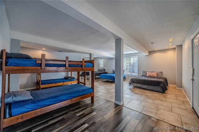 bedroom featuring wood-type flooring and a textured ceiling