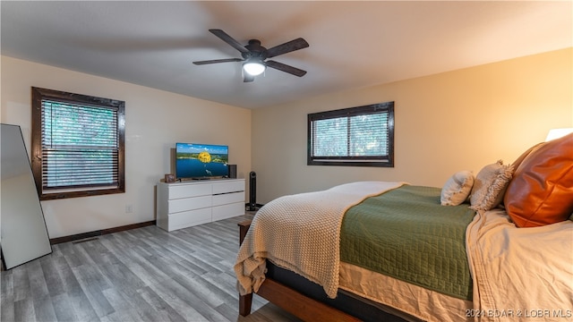 bedroom featuring hardwood / wood-style floors and ceiling fan