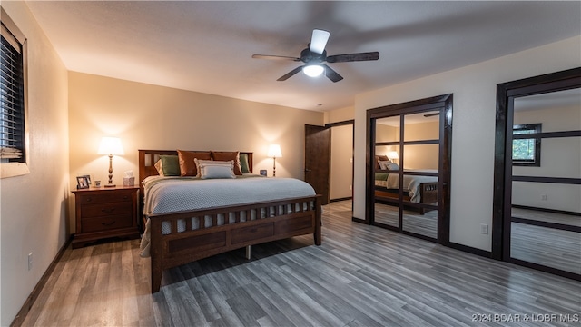 bedroom with dark hardwood / wood-style floors and ceiling fan