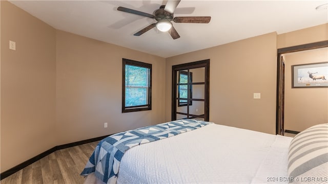 bedroom with hardwood / wood-style flooring and ceiling fan