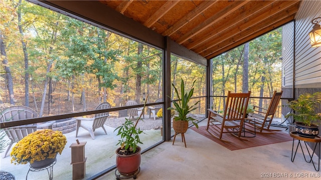 sunroom / solarium featuring lofted ceiling