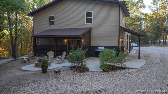 rear view of property with a patio and a sunroom