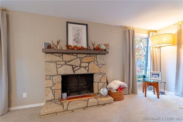 living area featuring a fireplace and carpet floors