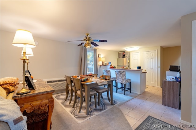 dining room featuring a wall unit AC, light tile patterned flooring, and ceiling fan