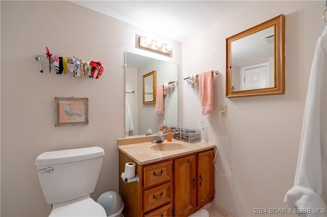 bathroom featuring vanity and toilet