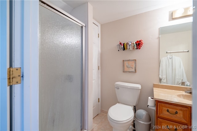 bathroom with toilet, an enclosed shower, vanity, and tile patterned flooring