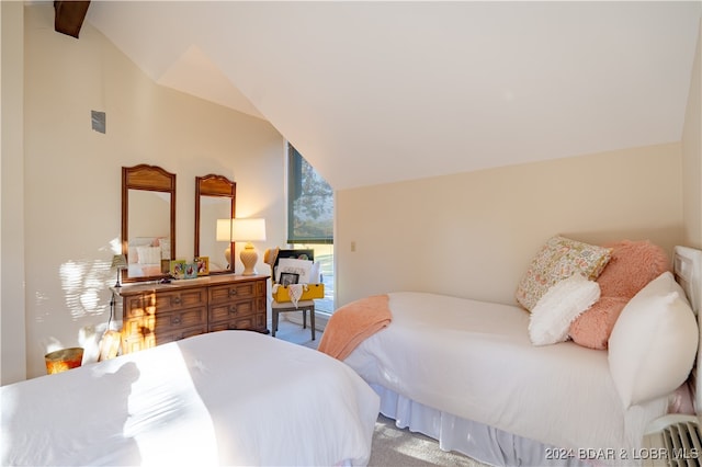 bedroom featuring carpet and vaulted ceiling with beams