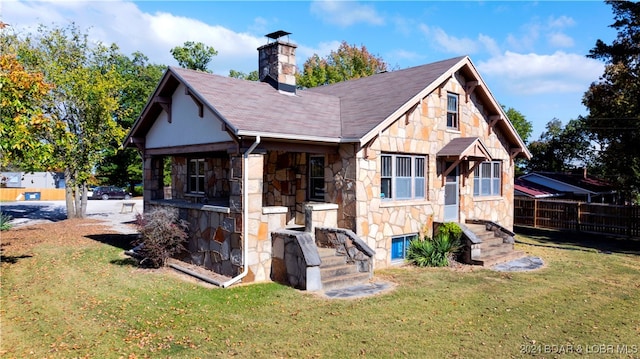 rear view of property featuring a yard