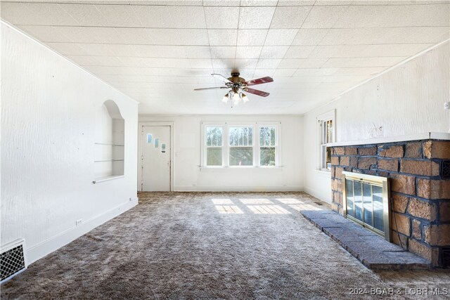 unfurnished living room featuring ceiling fan, carpet flooring, and a fireplace