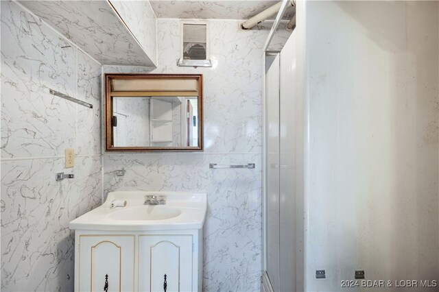 bathroom with tile walls and vanity