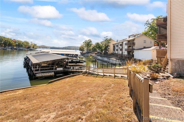 dock area with a yard and a water view