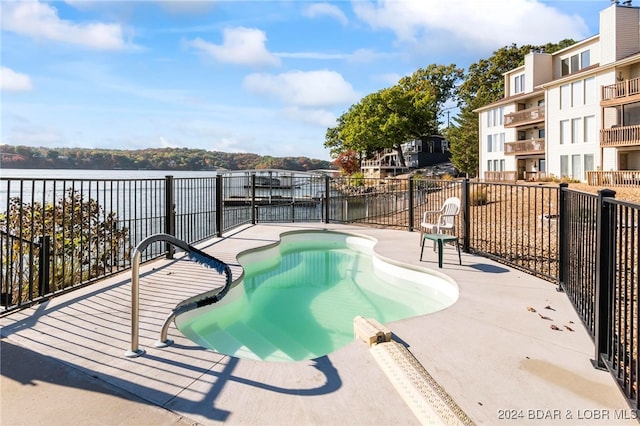 view of swimming pool with a water view