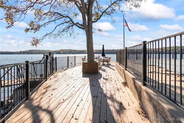 wooden terrace featuring a water view